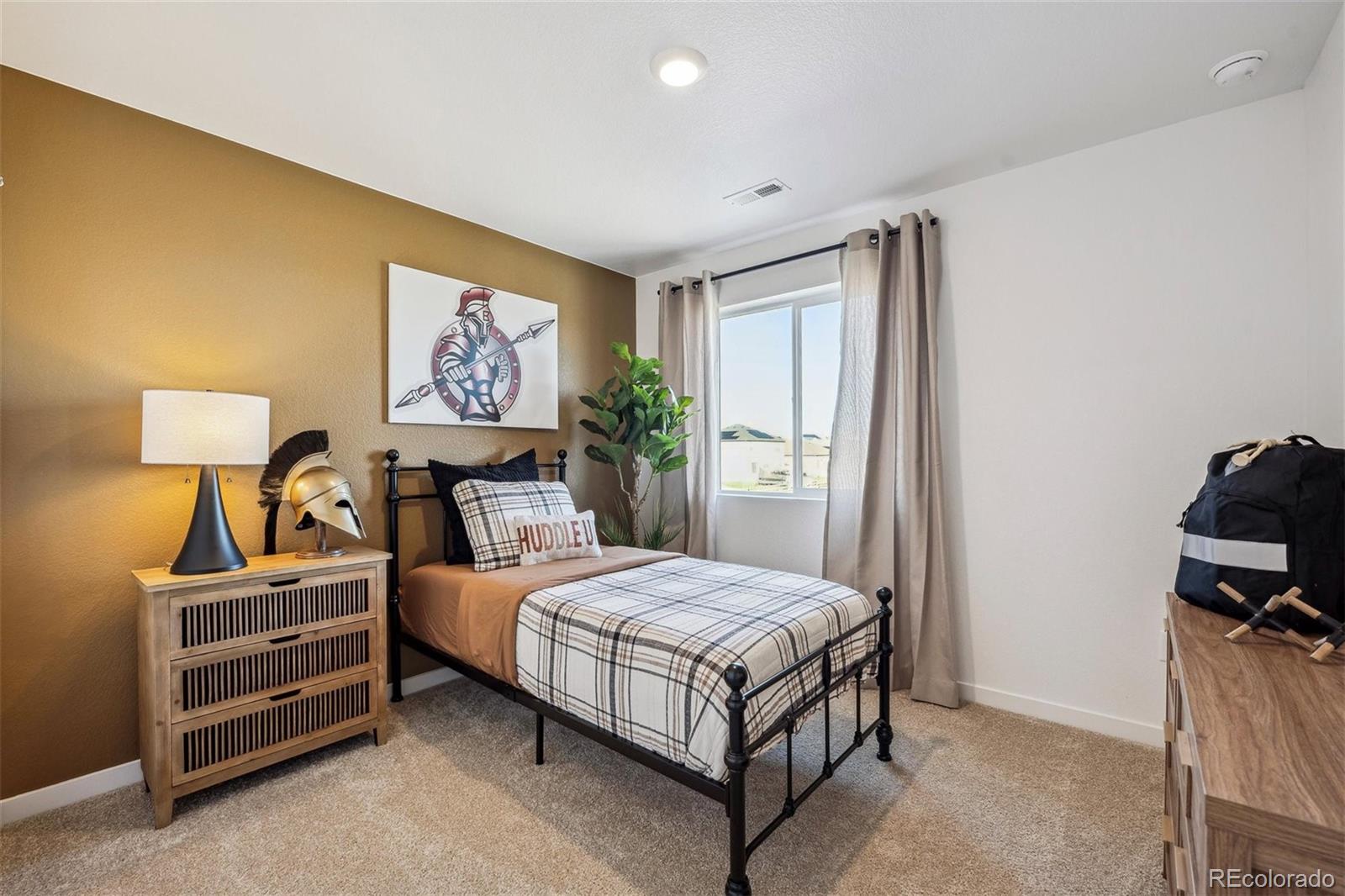 932 Logan Peak Way Berthoud, CO 80513 - Photo 20 of 34 a bedroom with a bed and a lamp on table