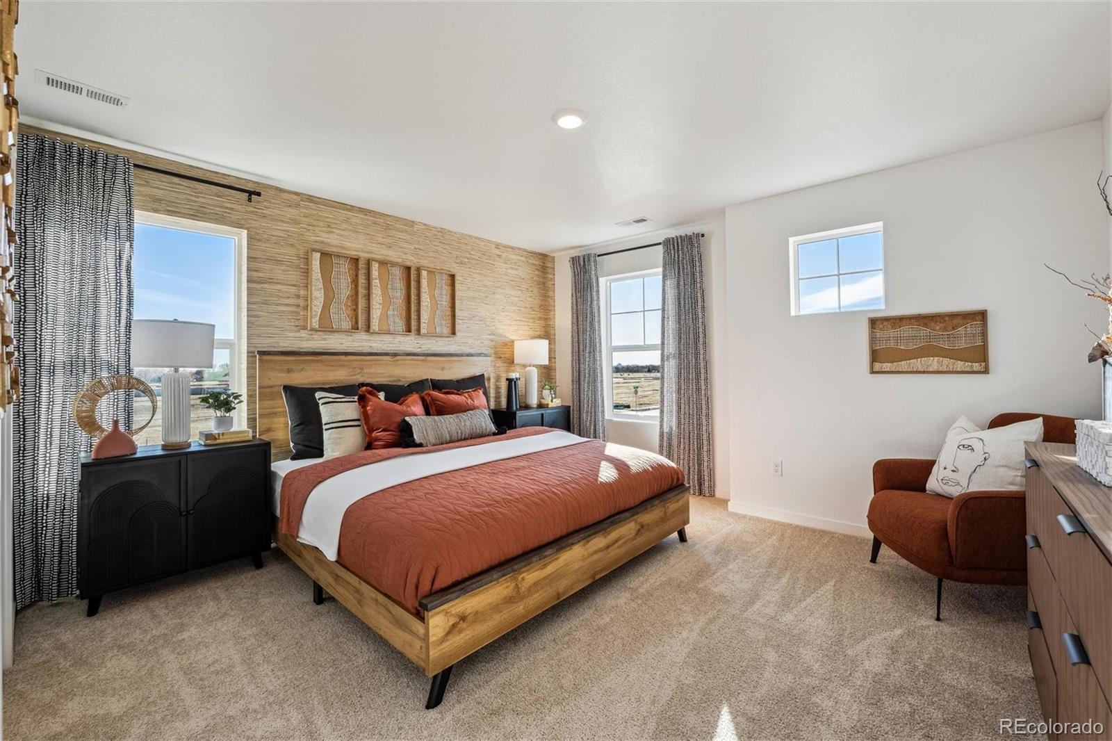 932 Logan Peak Way Berthoud, CO 80513 - Photo 21 of 34 a bedroom with a bed and a couch