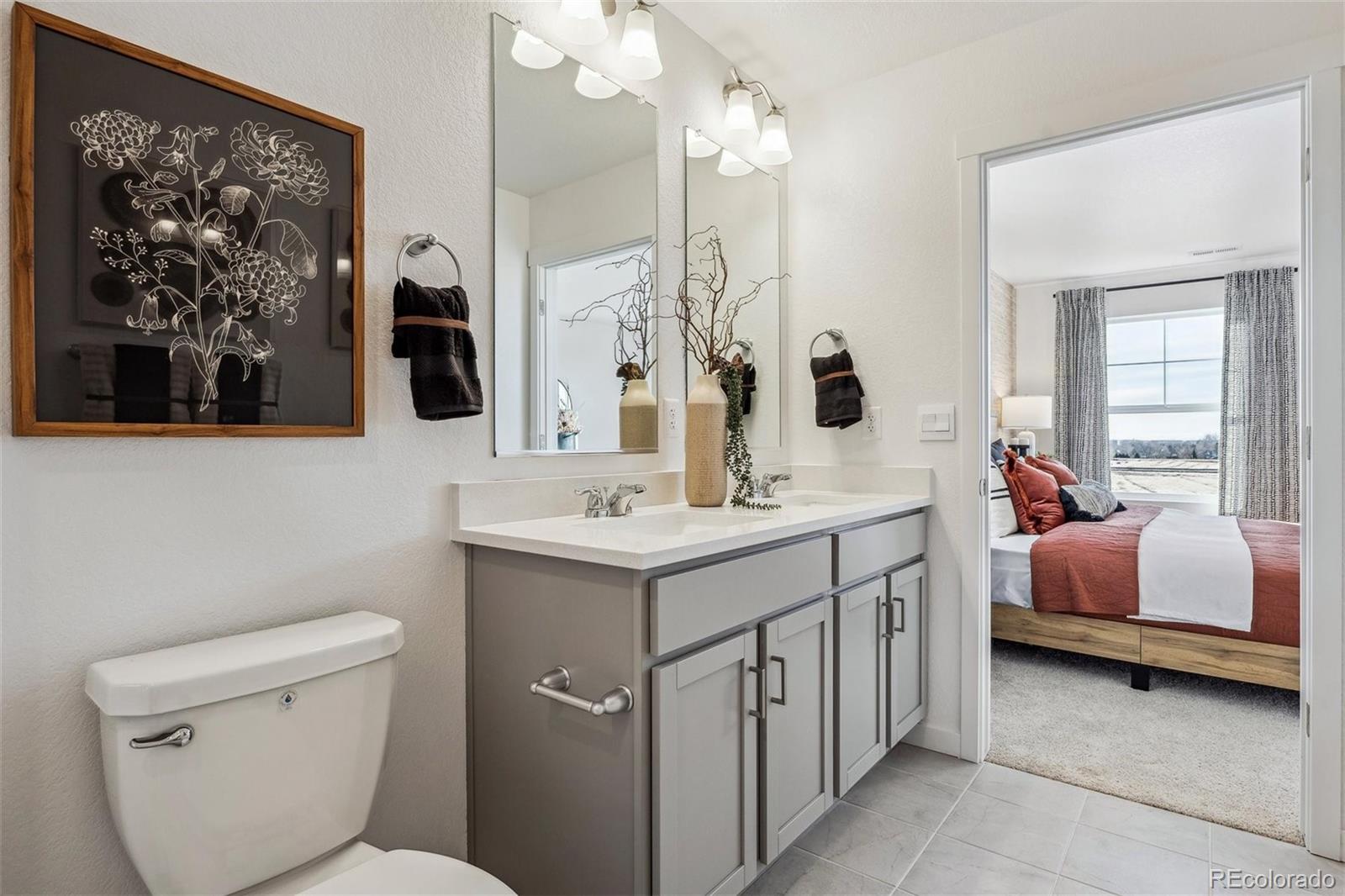 932 Logan Peak Way Berthoud, CO 80513 - Photo 23 of 34 a bathroom with a double vanity sink toilet and shower