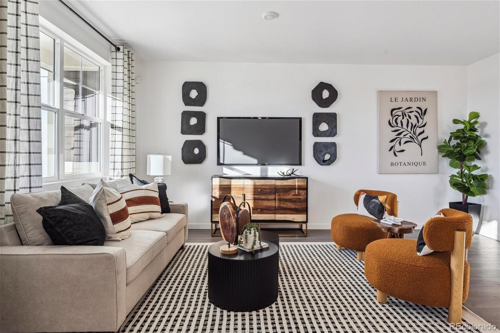 932 Logan Peak Way Berthoud, CO 80513 - Photo 3 of 34 a living room with furniture a rug and a window