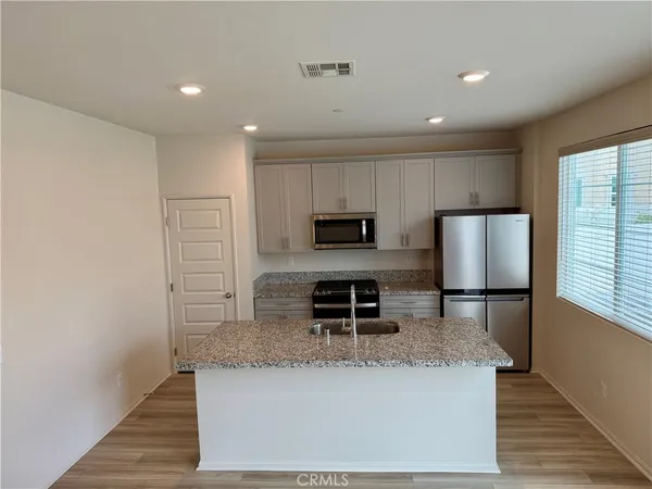 a stove top oven sitting inside of a kitchen