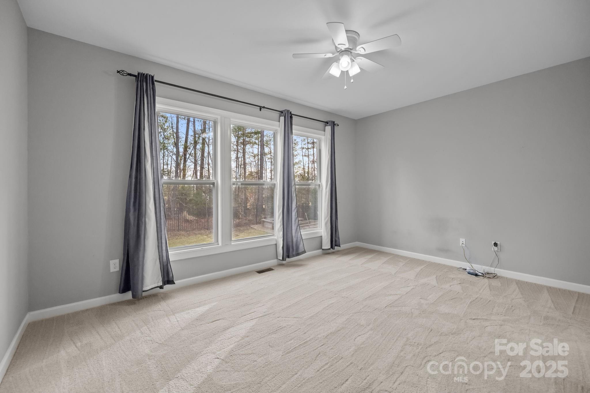 366 Hampton Trail Drive Fort Mill, SC 29708 - Photo 22 of 45 an empty room with chandelier fan and windows