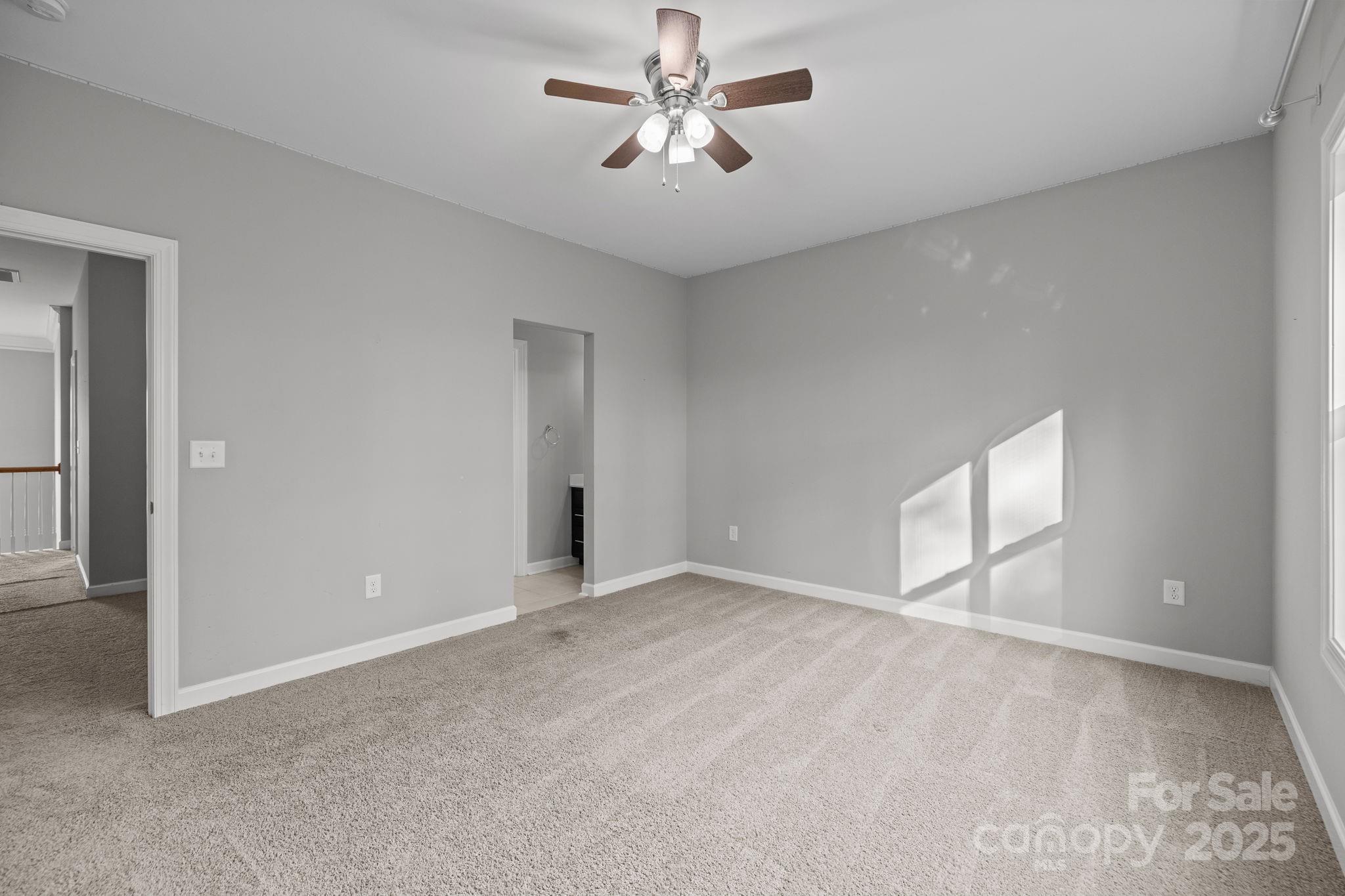 366 Hampton Trail Drive Fort Mill, SC 29708 - Photo 37 of 45 an empty room with chandelier fan and windows