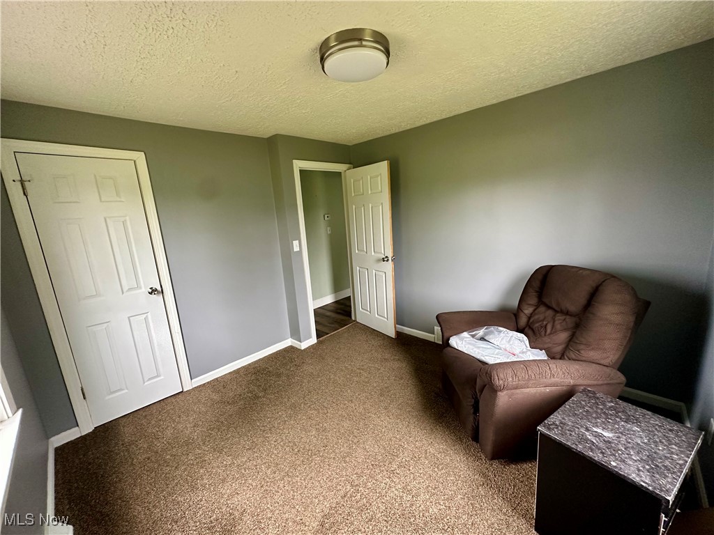4664 Kennedy Road Lowellville, OH 44436 - Photo 5 of 11 Bedroom with dark carpet and a textured ceiling