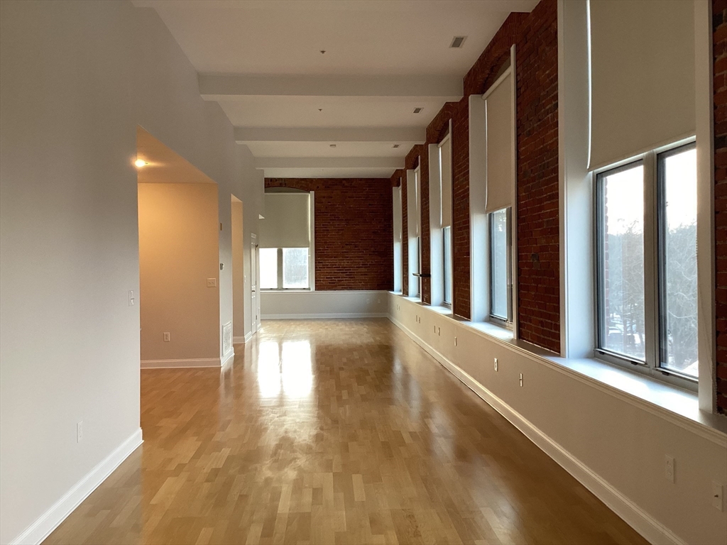 11 Lake Street, Unit 131 Wakefield, MA 01880 - Photo 2 of 11 a view of a hallway with wooden floor and staircase