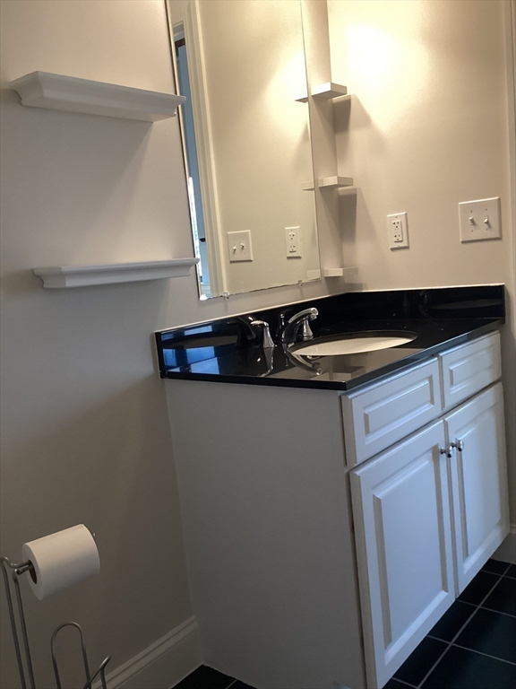 11 Lake Street, Unit 131 Wakefield, MA 01880 - Photo 9 of 11 a bathroom with a sink and a mirror