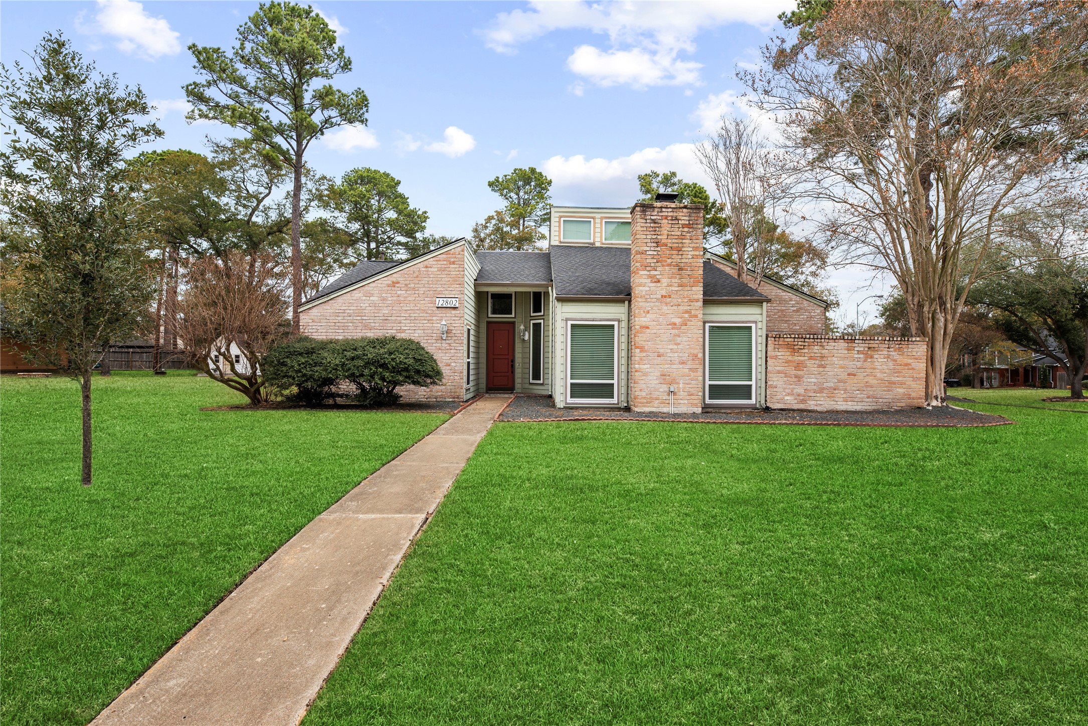 a front view of house with yard and green space