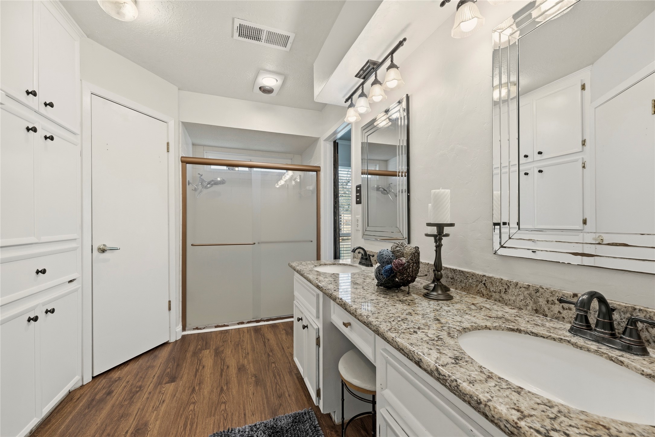 12802 Jarvis Road Cypress, TX 77429 - Photo 16 of 29 a bathroom with a granite countertop sink a mirror and shower