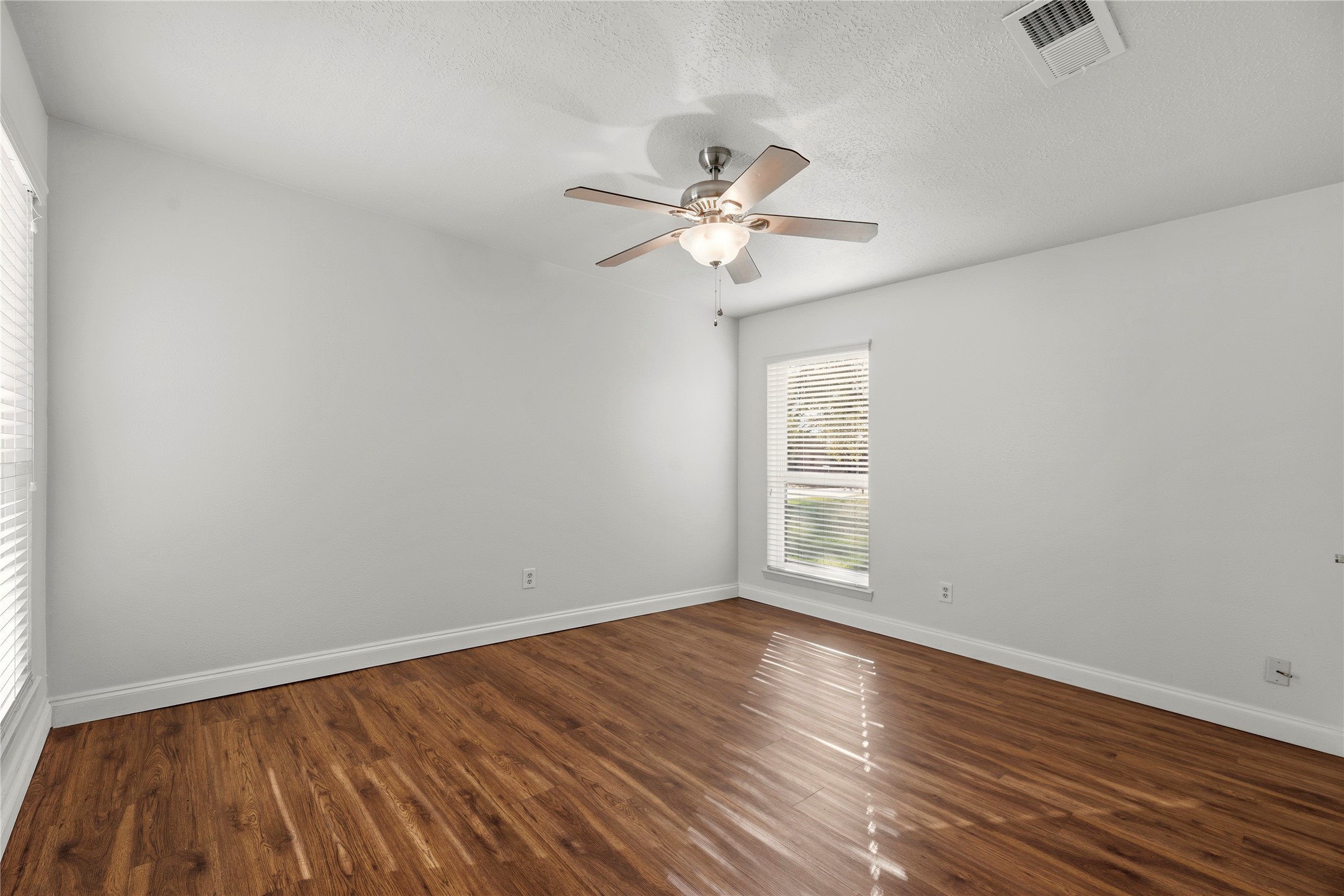 12802 Jarvis Road Cypress, TX 77429 - Photo 17 of 29 a view of empty room with wooden floor and fan