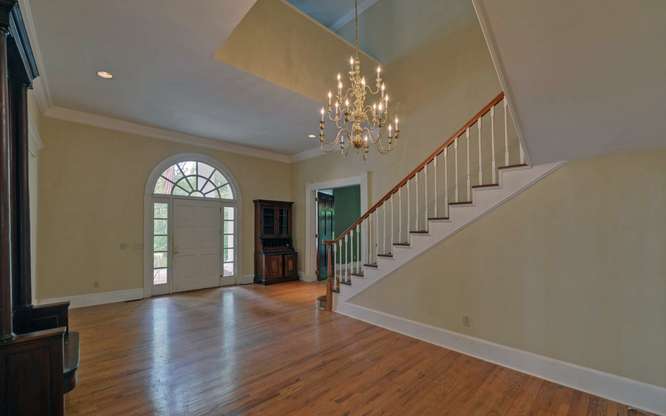 330 River Road Westminster, SC 29693 - Photo 9 of 45 A grand entrance with a sweeping staircase and a stately arched doorway beckons residents and guests.
