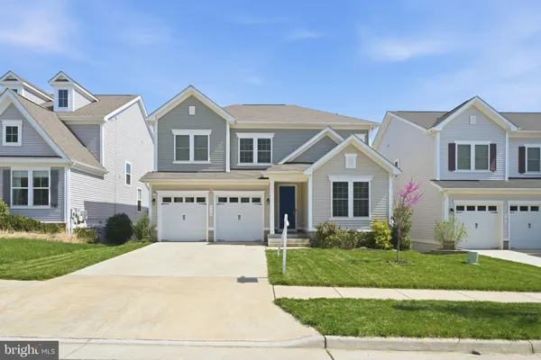 a front view of a house with a garden and plants