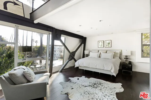 a bedroom with a bed and a couch