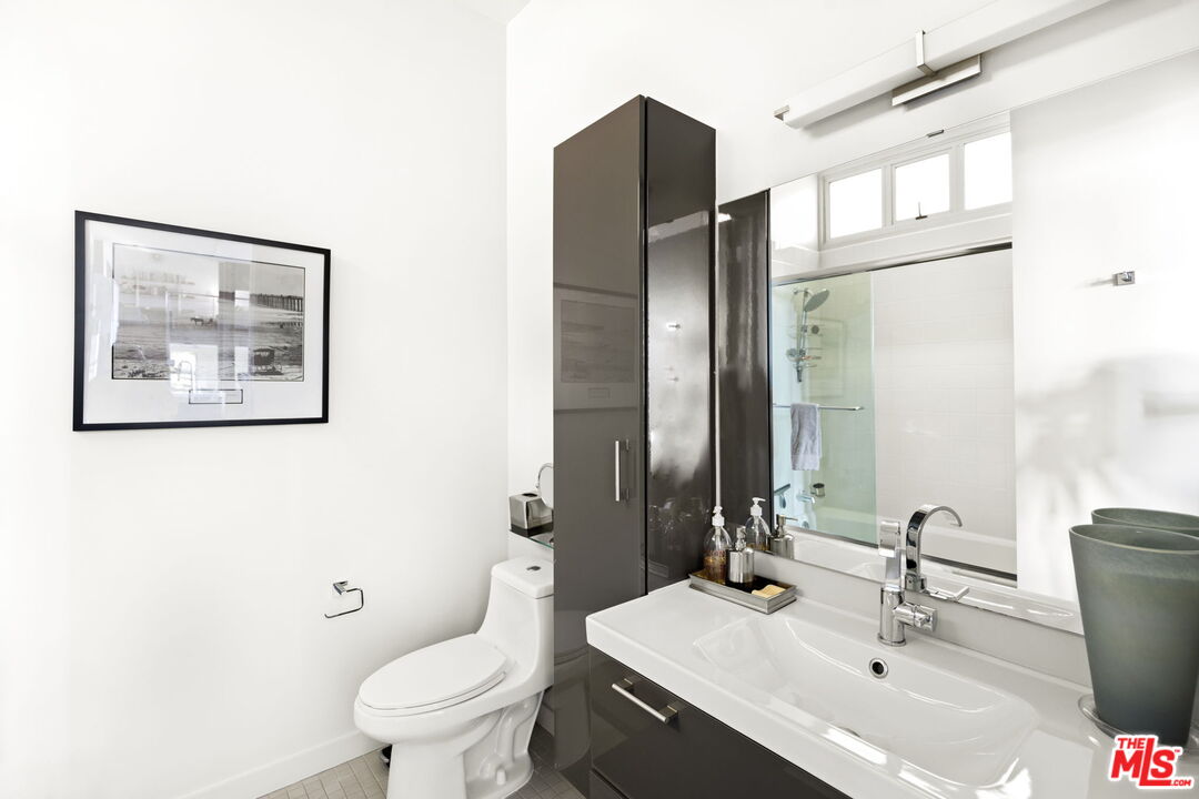 1513 9th Street, Unit 3 Santa Monica, CA 90401 - Photo 20 of 29 a bathroom with a toilet sink and mirror