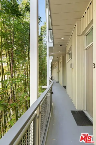 a balcony with a table and chairs