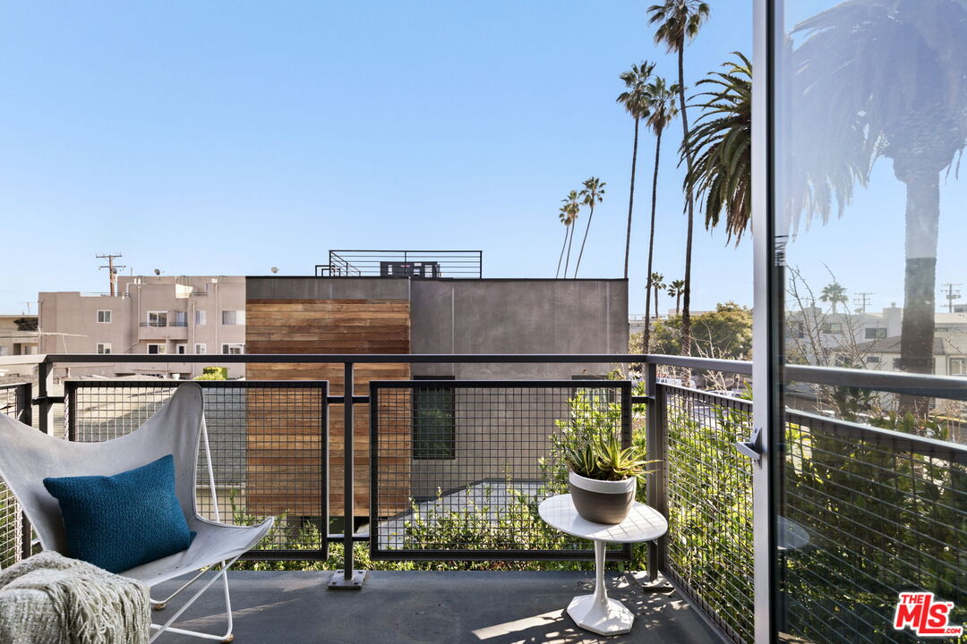 1513 9th Street, Unit 3 Santa Monica, CA 90401 - Photo 28 of 29 a balcony with a table and chairs