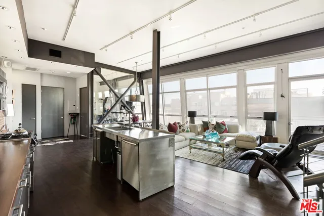a very nice looking living room with a large window and wooden floor