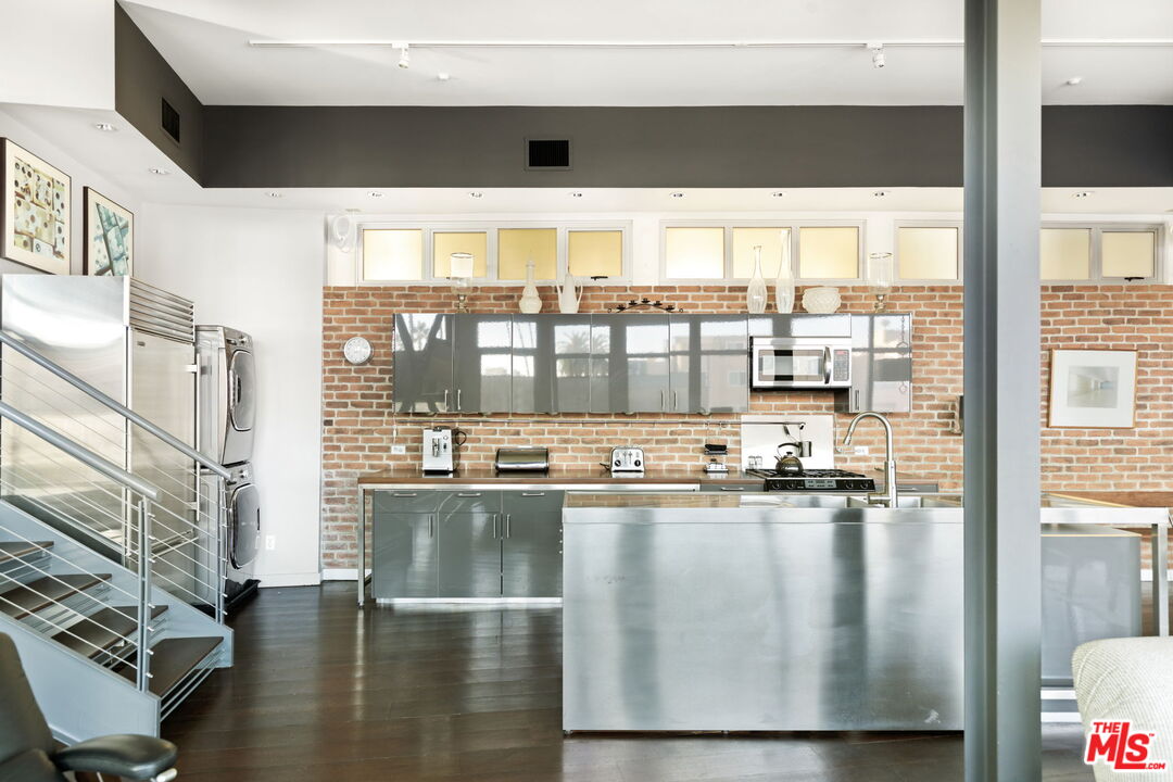 1513 9th Street, Unit 3 Santa Monica, CA 90401 - Photo 7 of 29 a kitchen with a large window appliances and cabinets