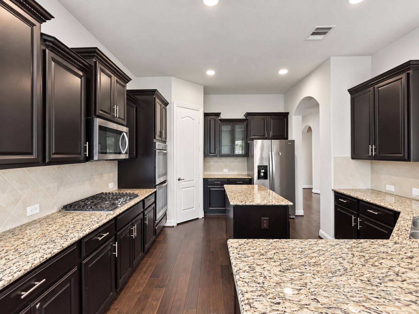 9626 Invergarry Way Tomball, TX 77375 - Photo 12 of 43 Additional kitchen view highlighting extensive cabinet and counter space, stainless steel appliances, center island, and recessed lighting.