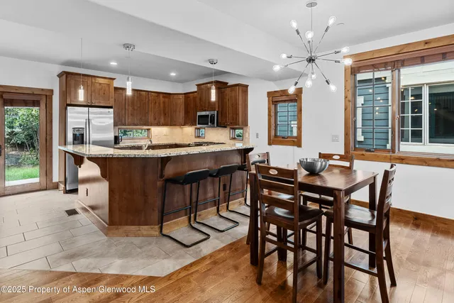 a dining table with chairs and window