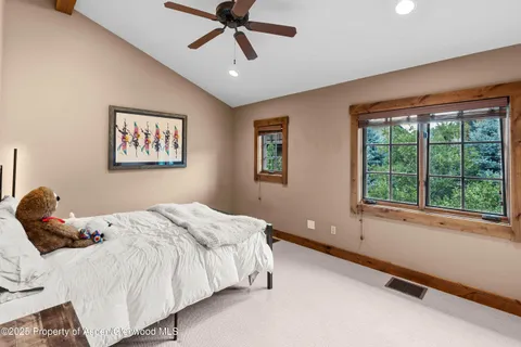 a bedroom with a large bed and a window