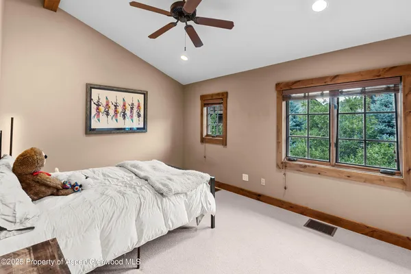 a bedroom with a large bed and a window