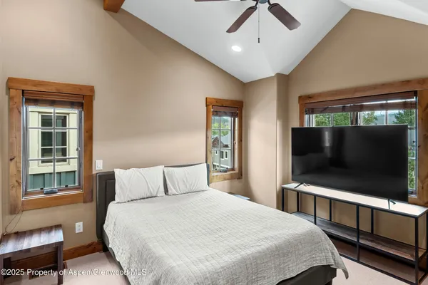 a bedroom with a bed and a flat screen tv