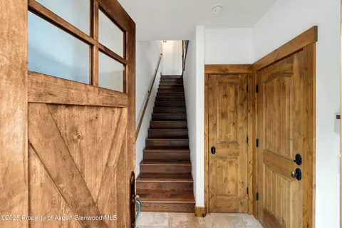a view of entryway with wooden floor and stairs