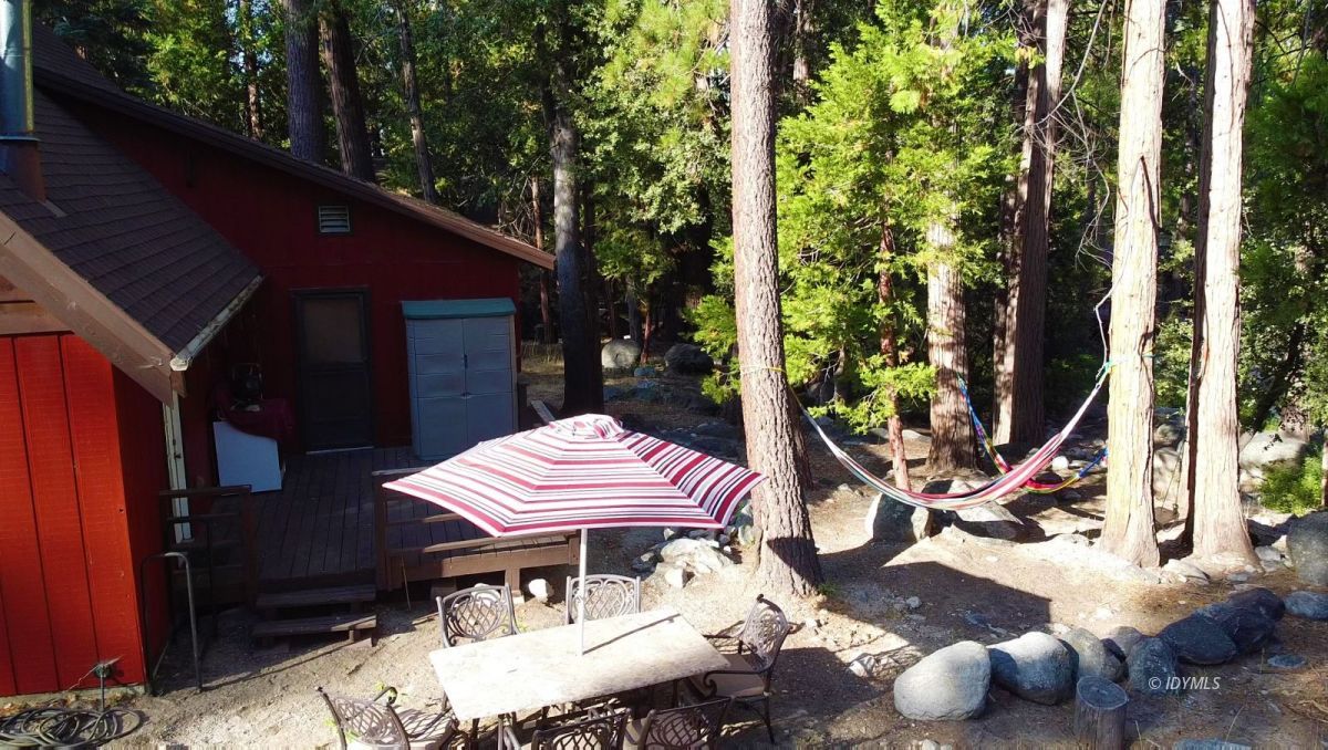 25125 Lodge Road Idyllwild, CA 92549 - Photo 17 of 26 a view of a patio with table and chairs under an umbrella