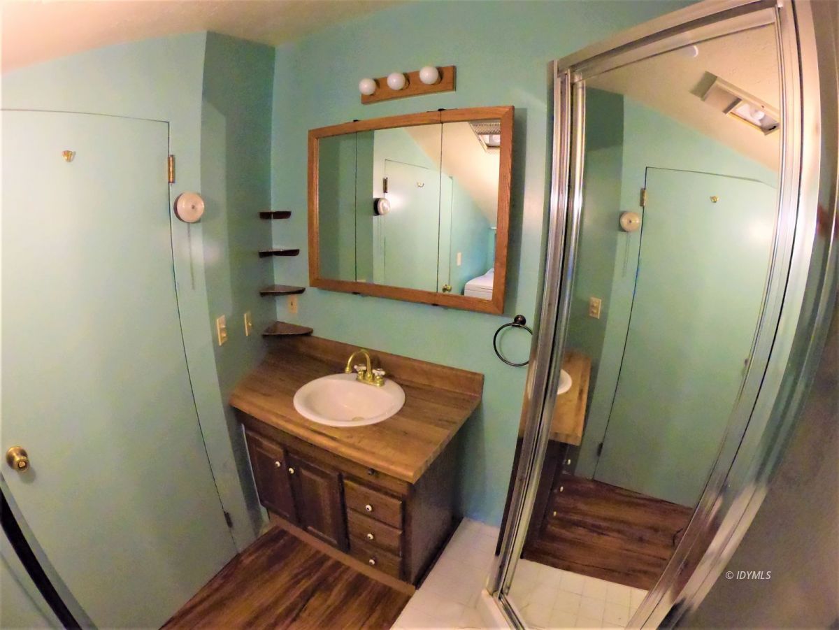 25125 Lodge Road Idyllwild, CA 92549 - Photo 20 of 26 a bathroom with a sink a mirror and a shower