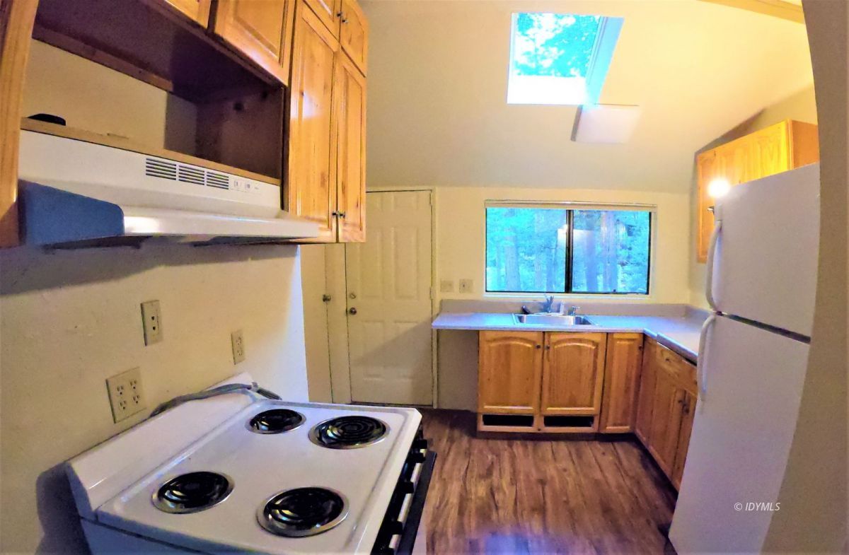 25125 Lodge Road Idyllwild, CA 92549 - Photo 21 of 26 a kitchen with a refrigerator and a sink