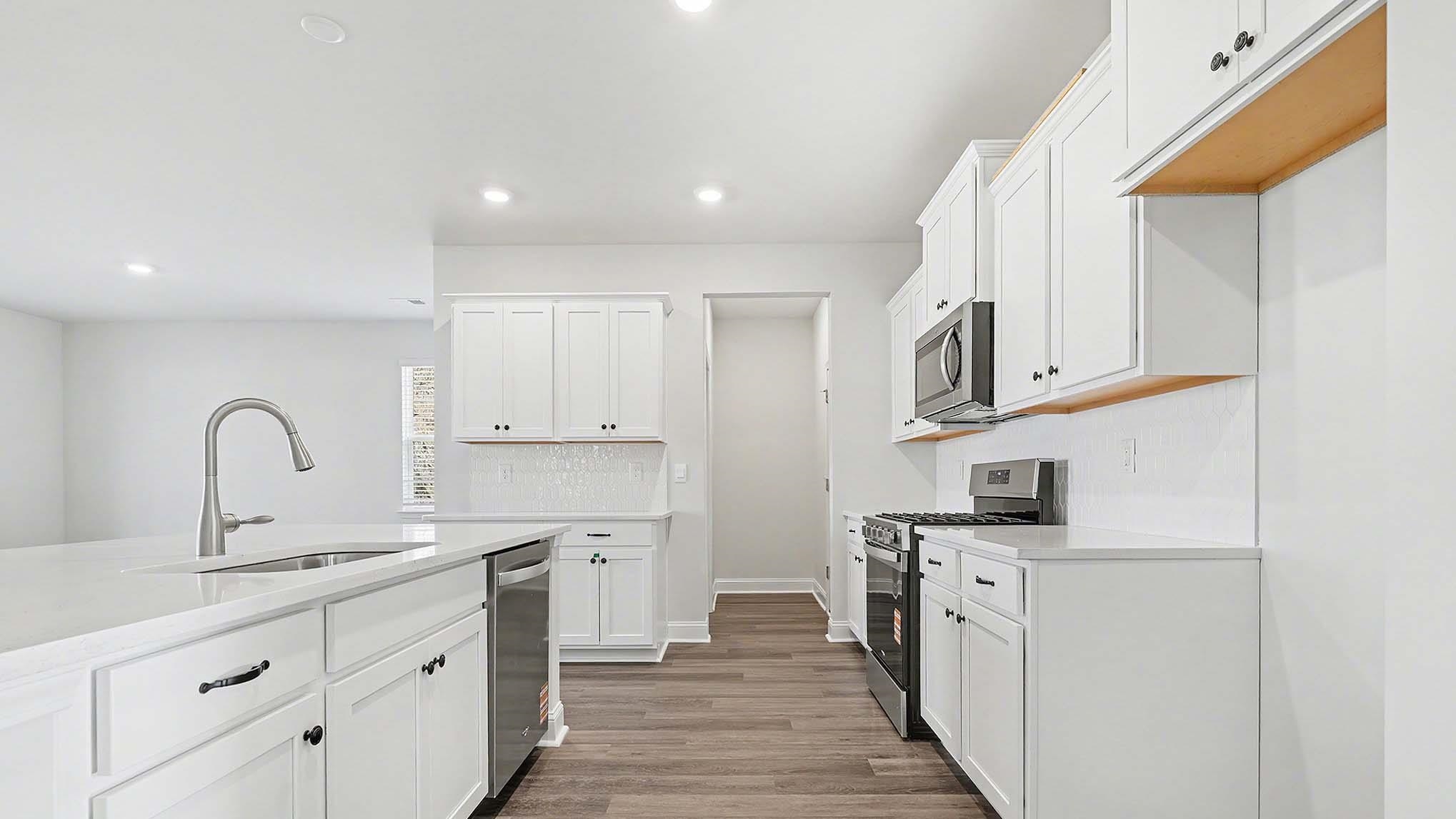 184 Bjorn Way Loris, SC 29569 - Photo 11 of 32 Kitchen featuring white cabinetry, appliances with stainless steel finishes, dark wood-style floors, and recessed lighting