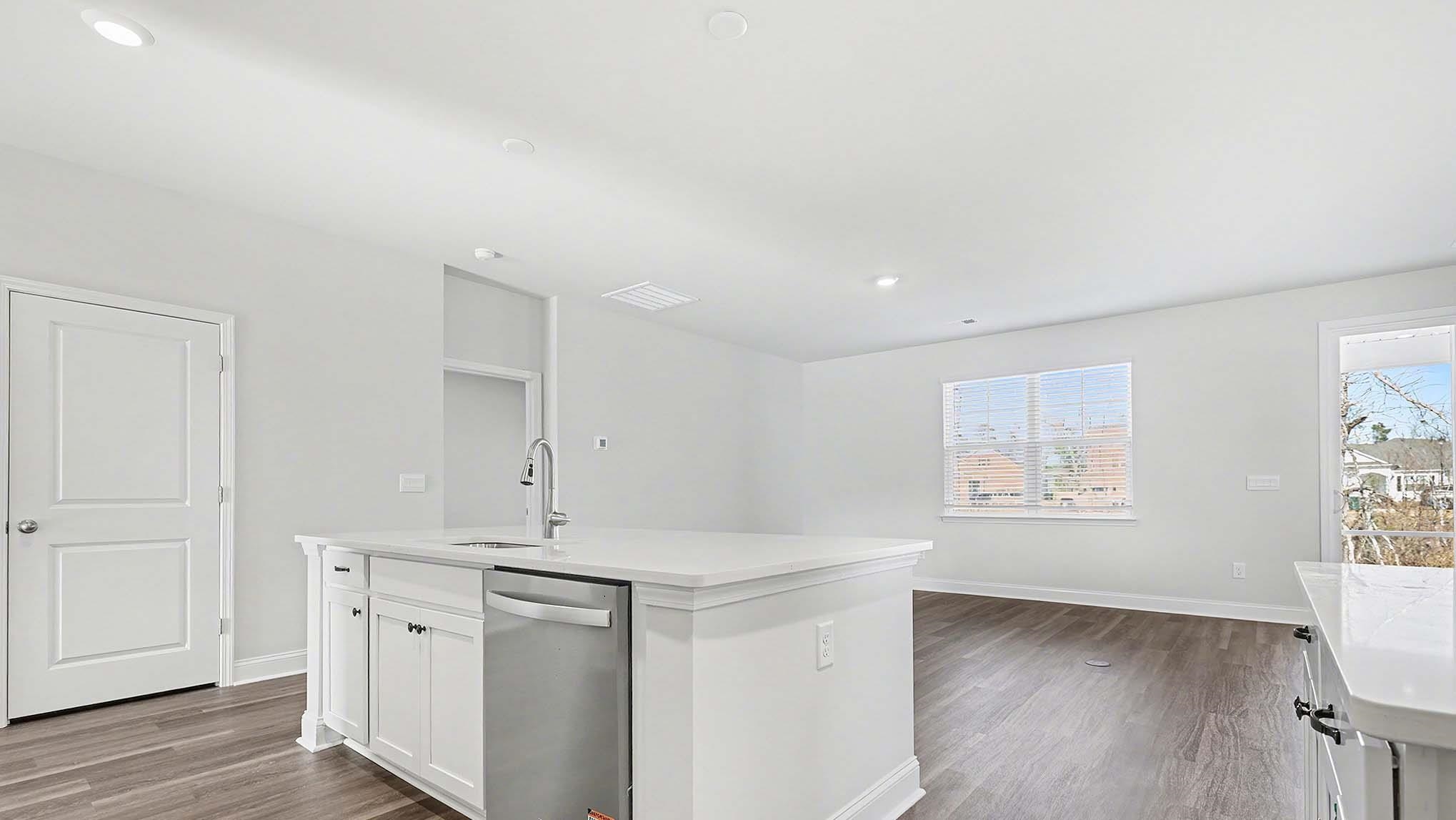 184 Bjorn Way Loris, SC 29569 - Photo 14 of 32 Kitchen featuring white cabinetry, dishwasher, an island with sink, dark wood-type flooring, and recessed lighting