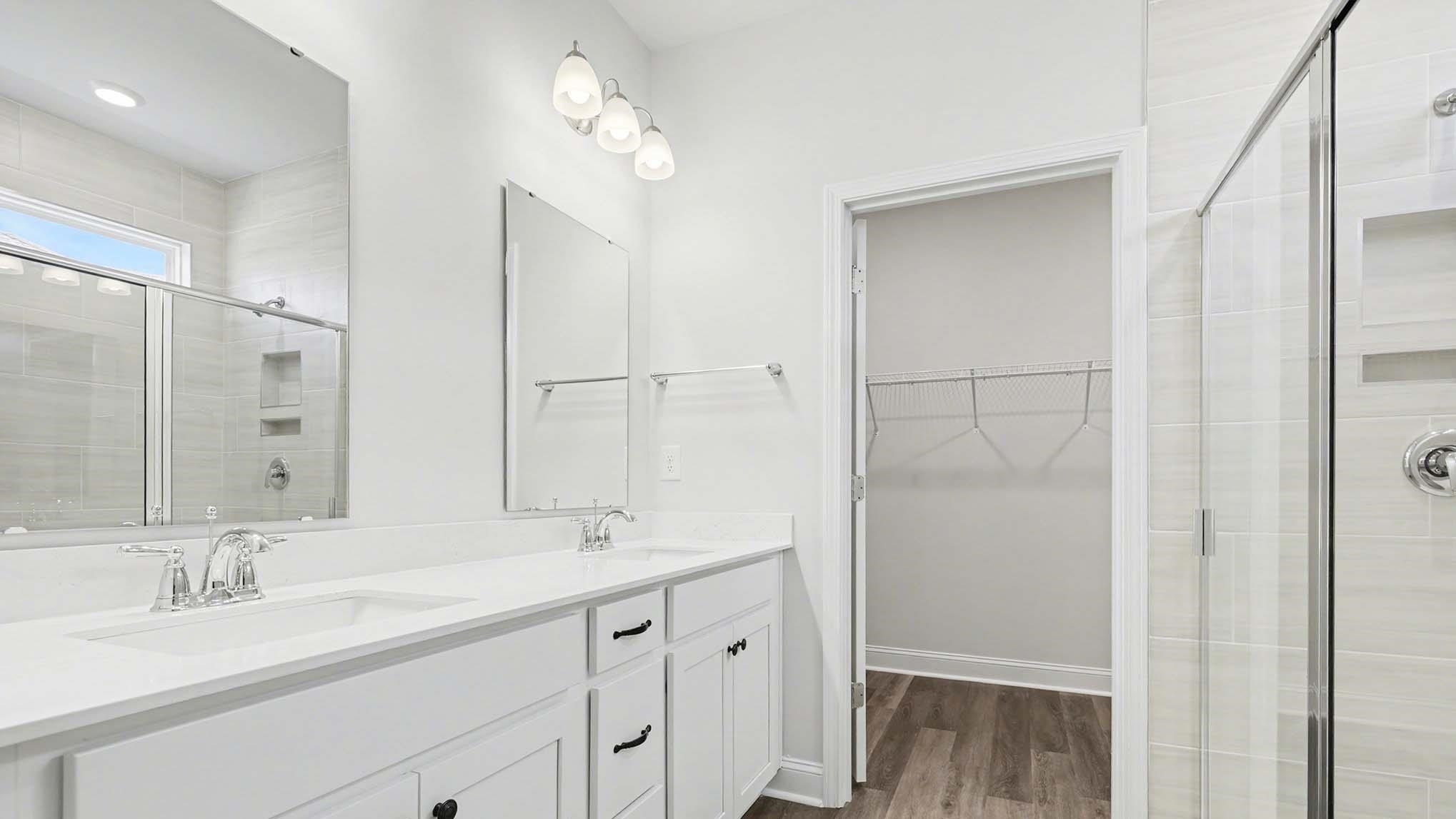 184 Bjorn Way Loris, SC 29569 - Photo 19 of 32 Full bath with a stall shower, double vanity, dark wood-type flooring, and a spacious closet
