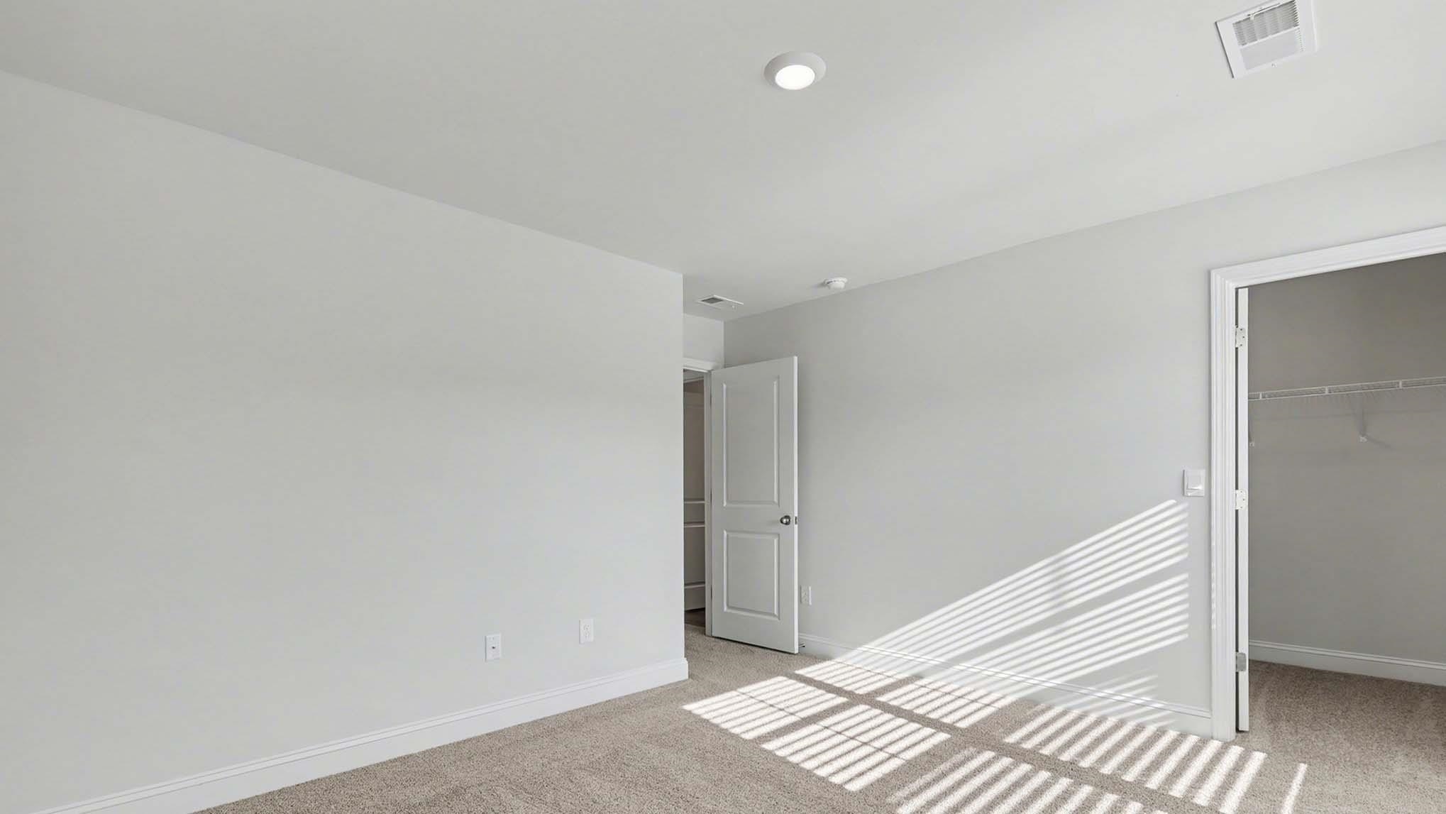 184 Bjorn Way Loris, SC 29569 - Photo 27 of 32 Unfurnished bedroom with light carpet and a walk in closet