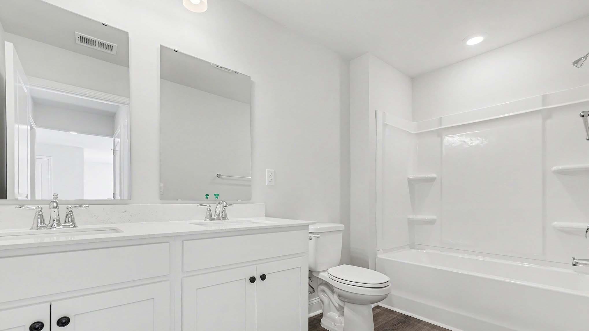 184 Bjorn Way Loris, SC 29569 - Photo 29 of 32 Full bath featuring tub / shower combination, double vanity, and dark wood finished floors