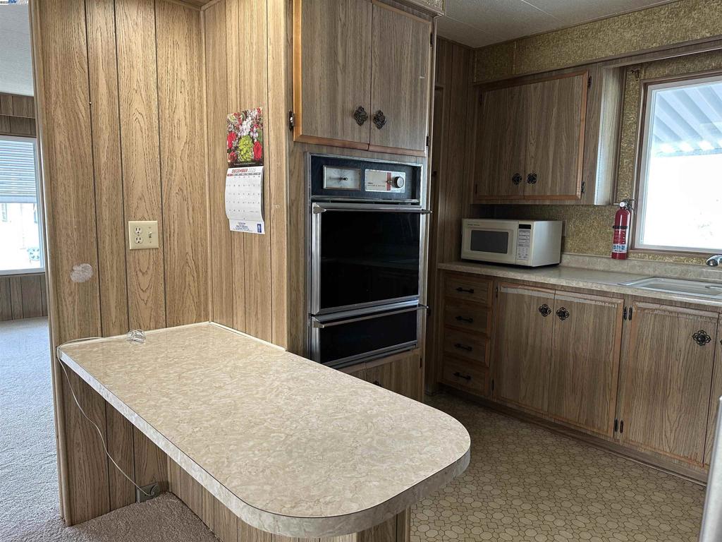 711 Old Canyon Road Fremont, CA 94538 - Photo 14 of 39 a kitchen with stainless steel appliances a kitchen island a stove a refrigerator and cabinets