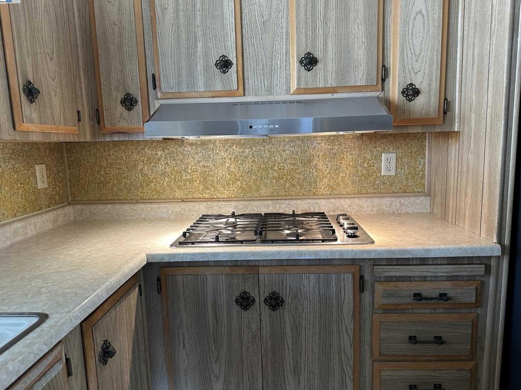 711 Old Canyon Road Fremont, CA 94538 - Photo 18 of 39 a kitchen with granite countertop cabinets and stove