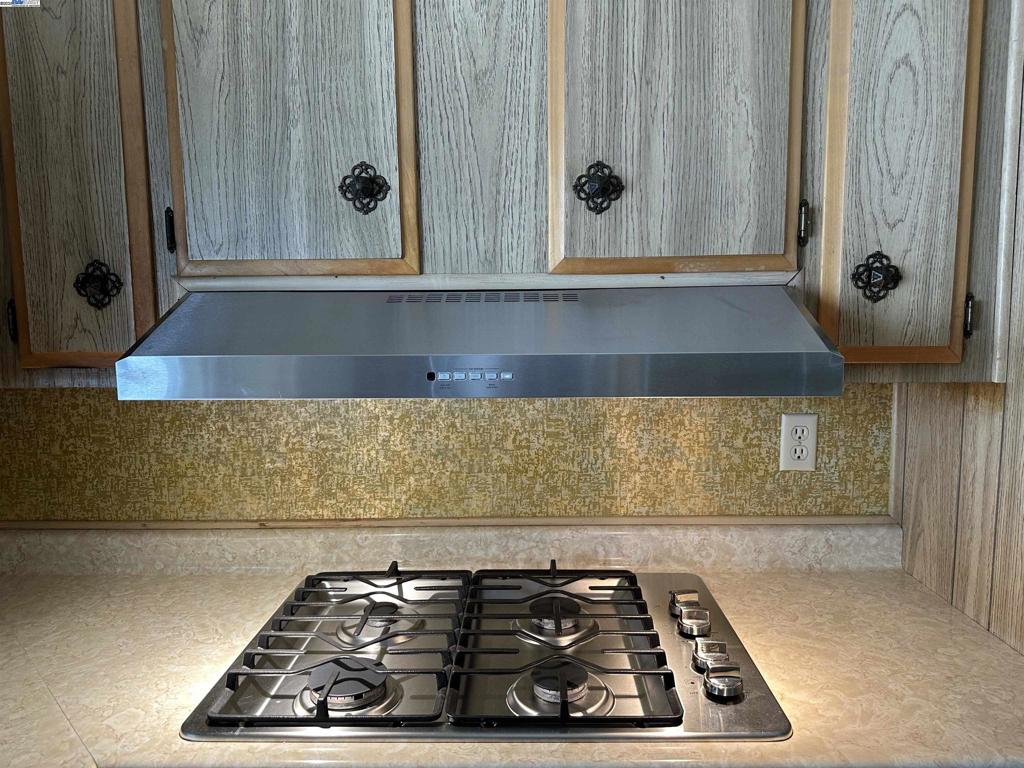 711 Old Canyon Road Fremont, CA 94538 - Photo 19 of 39 a kitchen with a stove and a cabinet