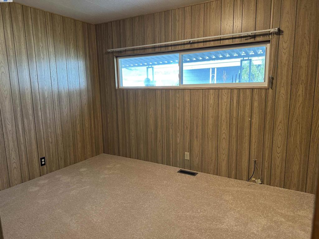 711 Old Canyon Road Fremont, CA 94538 - Photo 23 of 39 a view of an empty room with wooden floor and a window