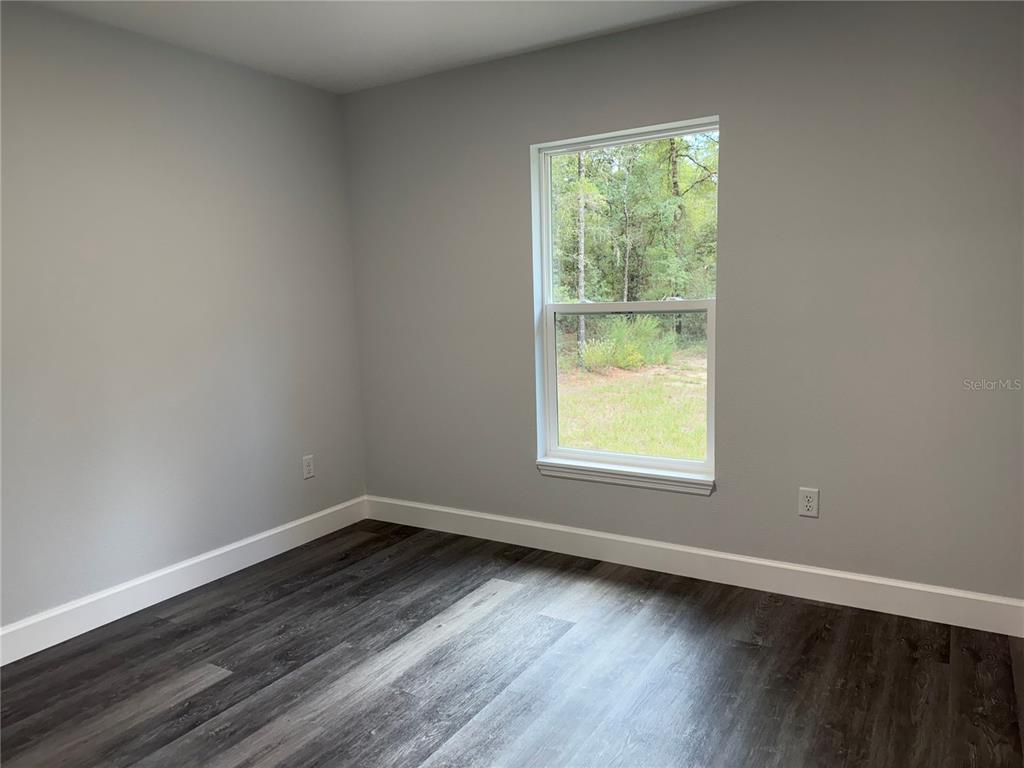 15424 Southwest 27th Lane Ocala, FL 34481 - Photo 12 of 21 a view of a room with wooden floor and window