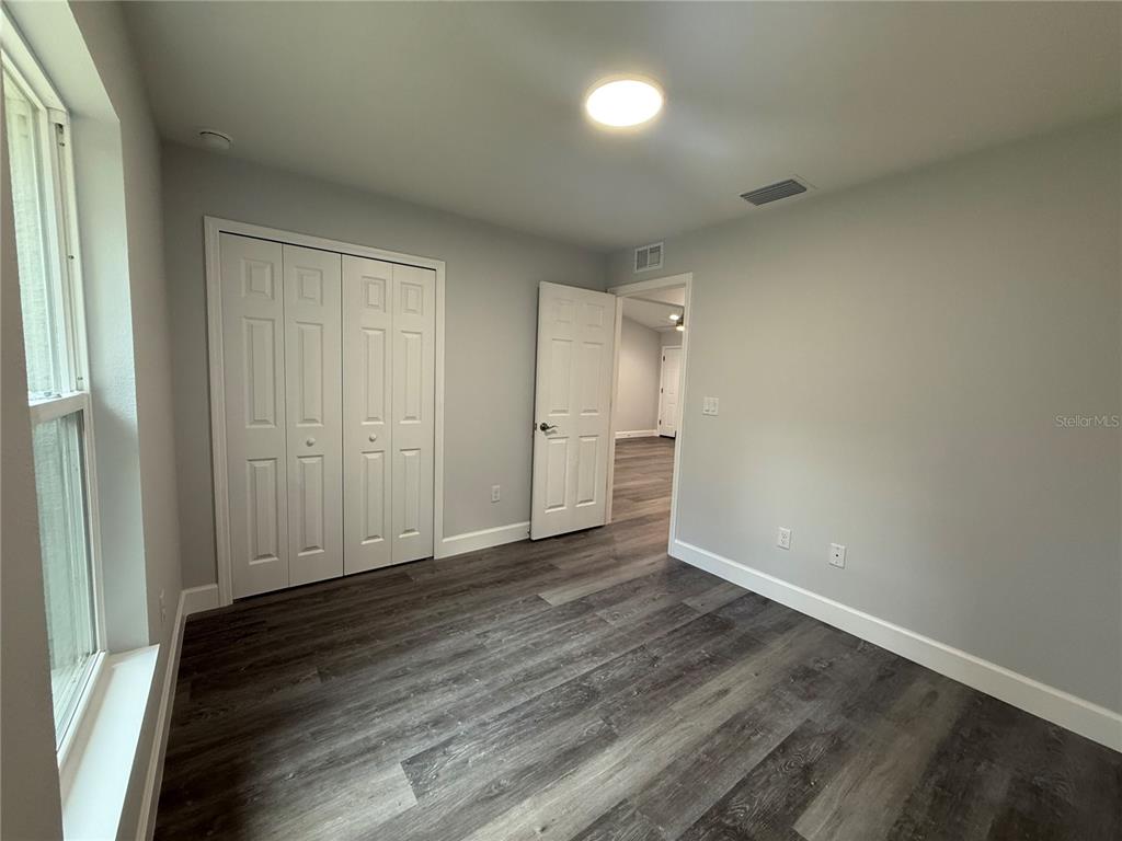 15424 Southwest 27th Lane Ocala, FL 34481 - Photo 13 of 21 wooden floor in an empty room with a window