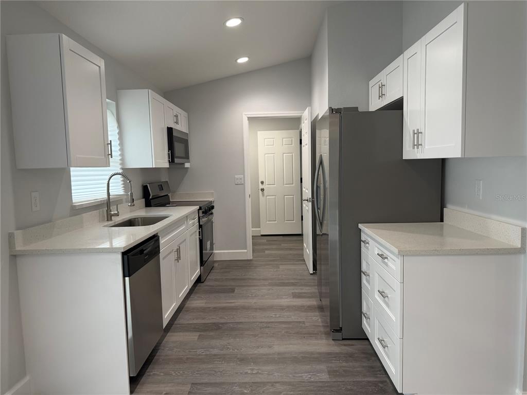 15424 Southwest 27th Lane Ocala, FL 34481 - Photo 15 of 21 a kitchen with a sink stove and refrigerator