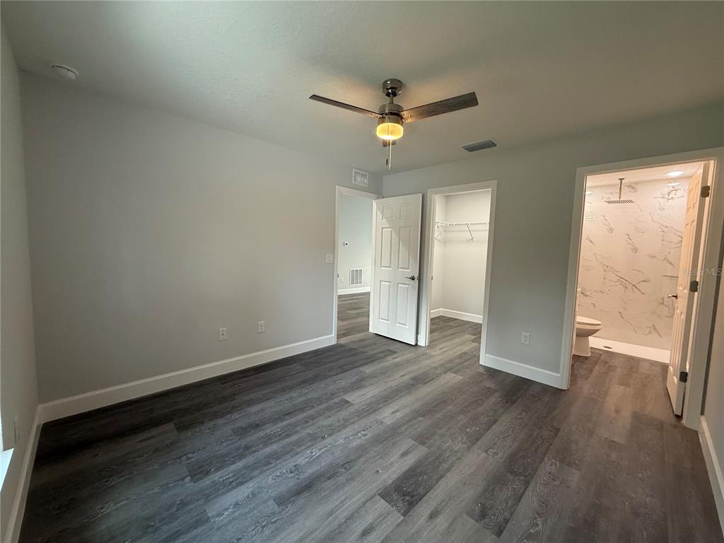 15424 Southwest 27th Lane Ocala, FL 34481 - Photo 16 of 21 an empty room with wooden floor and windows