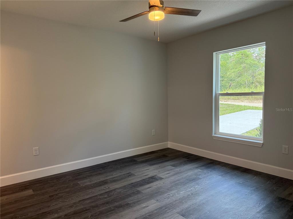 15424 Southwest 27th Lane Ocala, FL 34481 - Photo 17 of 21 an empty room with wooden floor and windows