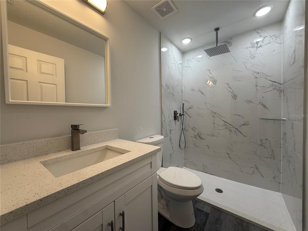 15424 Southwest 27th Lane Ocala, FL 34481 - Photo 18 of 21 a bathroom with a sink a toilet and shower