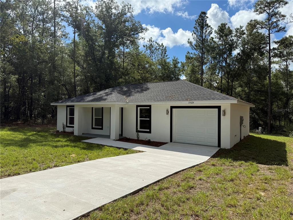 15424 Southwest 27th Lane Ocala, FL 34481 - Photo 2 of 21 a front view of a house with a yard