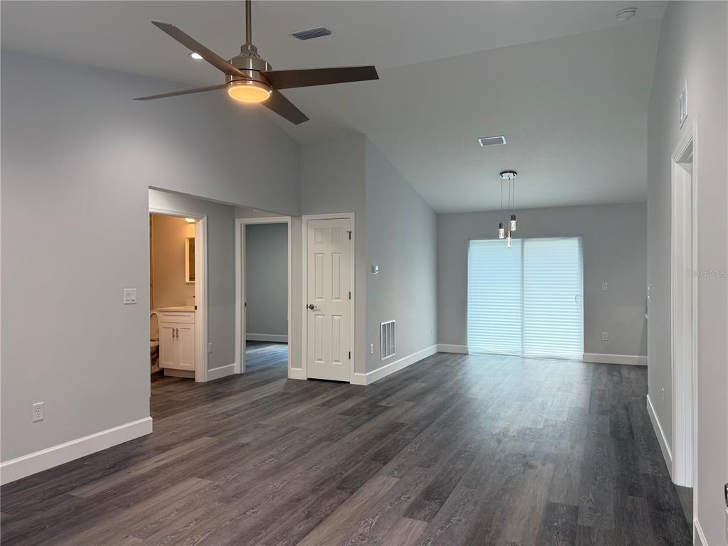 15424 Southwest 27th Lane Ocala, FL 34481 - Photo 5 of 21 an empty room with wooden floor a ceiling fan and closet