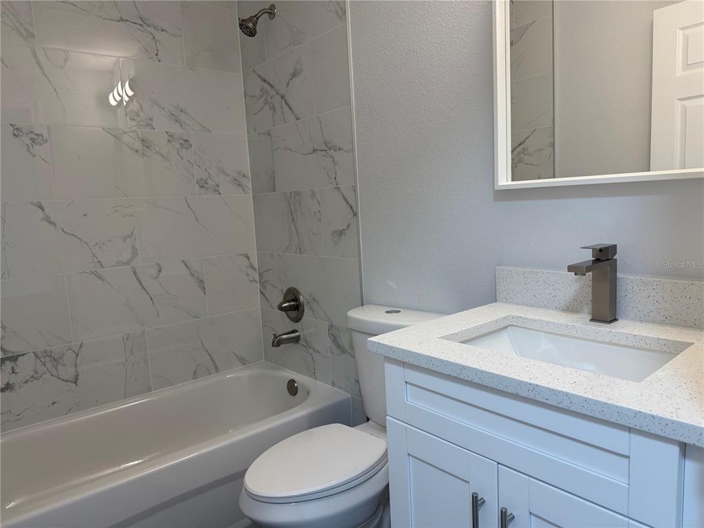 15424 Southwest 27th Lane Ocala, FL 34481 - Photo 10 of 21 a bathroom with a sink toilet vanity and bathtub