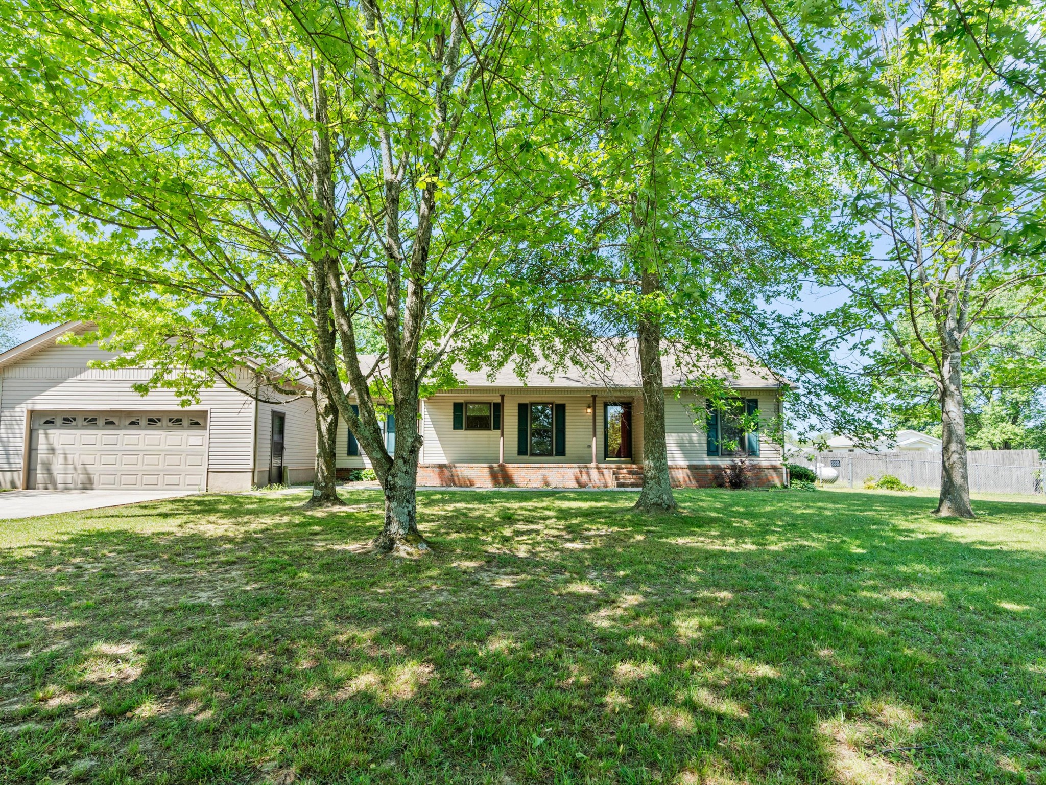 a front view of house with yard and green space