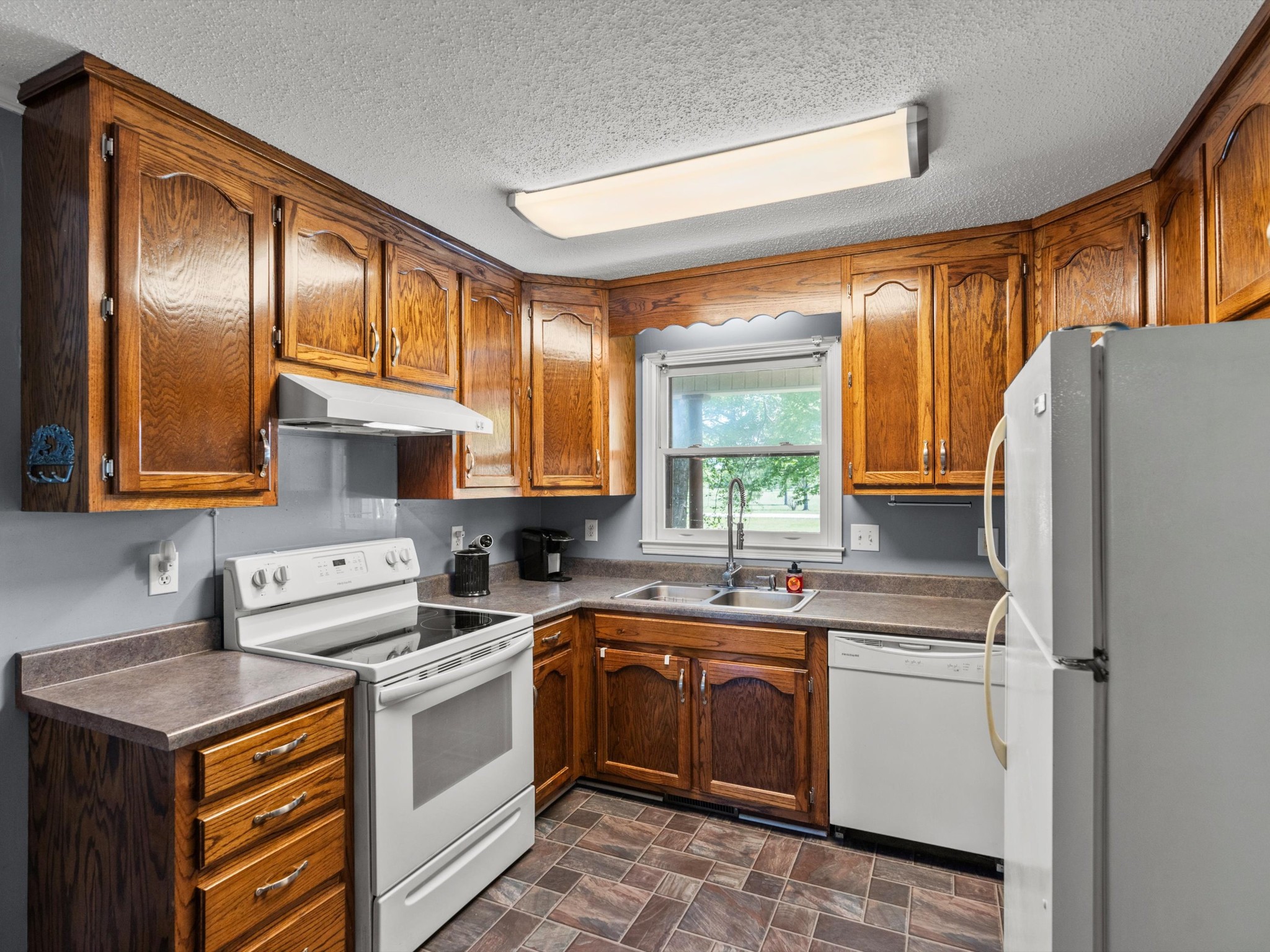 6934 Old Railroad Bed Road Toney, AL 35773 - Photo 9 of 38 a kitchen with a sink stove and refrigerator